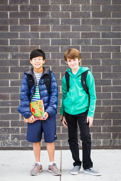 Outdoor portrait of two boys with backpacks