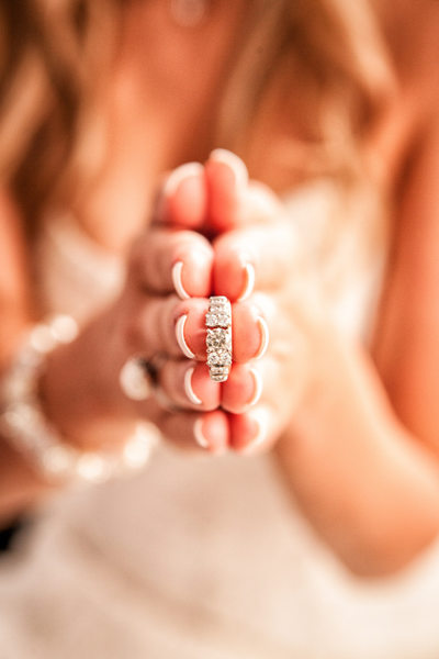 Unique photo of bride holding her wedding band.