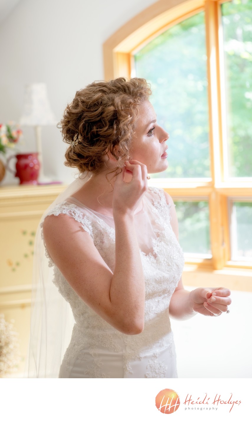 bride getting ready with earrings
