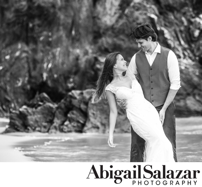 Destination wedding: Smiling bride and groom on the beach
