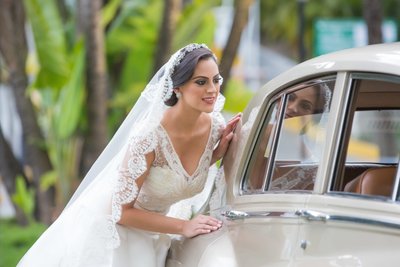 Gorgeous & elegant bride poses by wedding car
