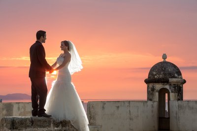 Bride and Groom holding hands: Castle sunset portrait