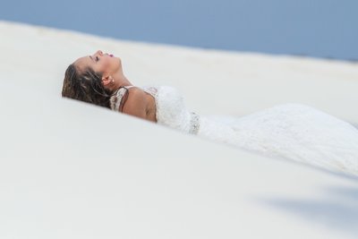 Destination wedding: Bride and wet dress by the sea