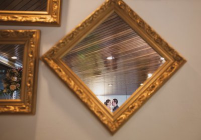 Indoor bride and groom portrait: Mirror reflection