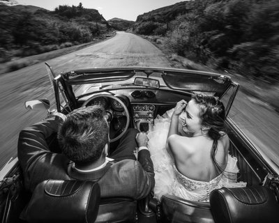 Bride & Groom driving the weeding car: Glamorous couple
