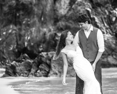 Destination wedding: Smiling bride and groom on the beach