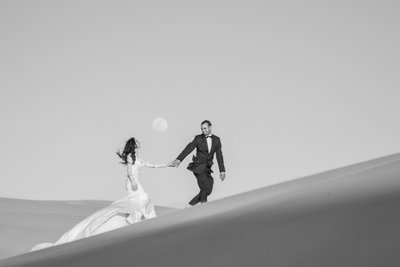 Bride & Groom walking in the sand desert
