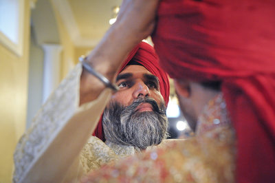 DFW Indian Sikh Weddings Father Places Turban On Son
