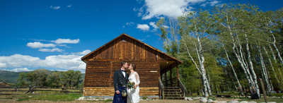 Couple by cabin and aspens in Steamboat Springs wedding