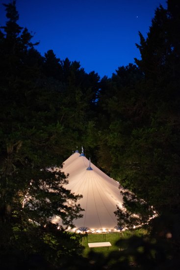 Sailcloth tent tucked into historic New England woods