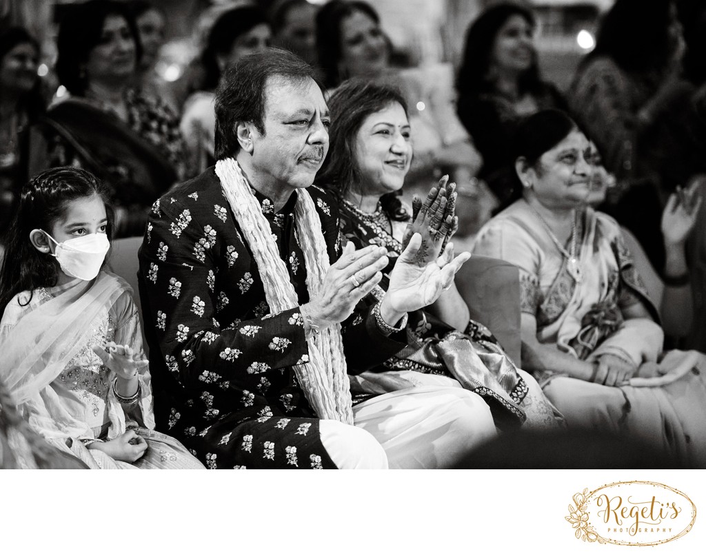 Parents clapping at the sangeet ceremony