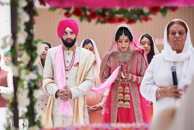 Sikh bride and groom praying 
