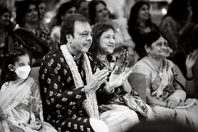 Parents clapping at the sangeet ceremony