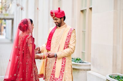 Groom seeing his Indian bride for the first time.