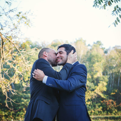 grooms embrace on wedding day gay lgbt 