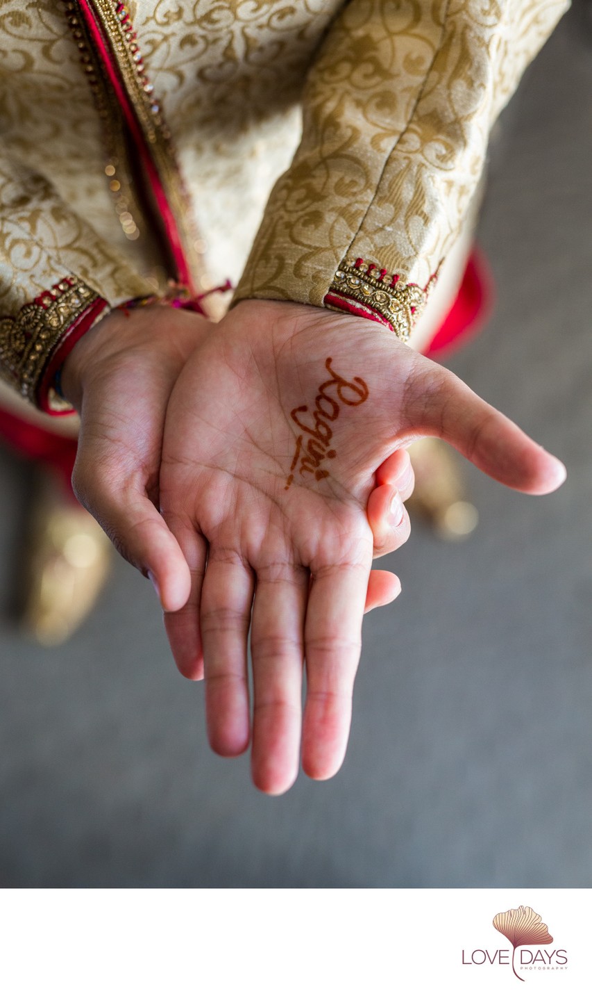 Boston Indian groom with henna paint brides name