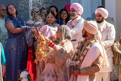 Tanya throws rice during Indian Wedding ceremony