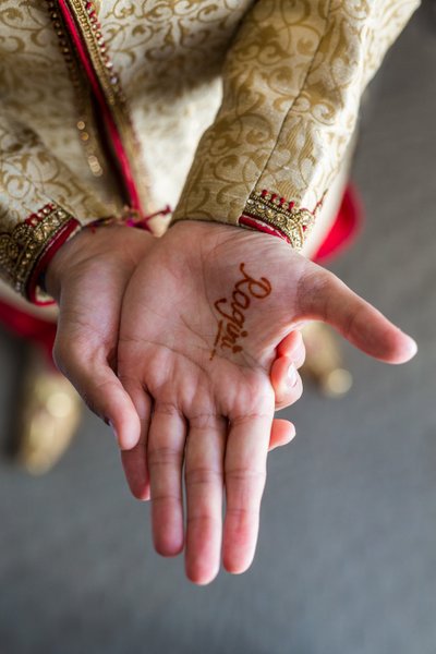 Boston Indian groom with henna paint brides name