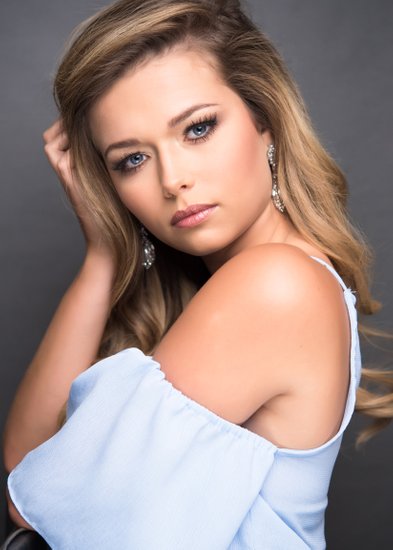 Pageant queen headshot in baby blue shirt