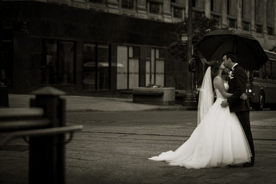 Bride and Groom kissing in the Rain