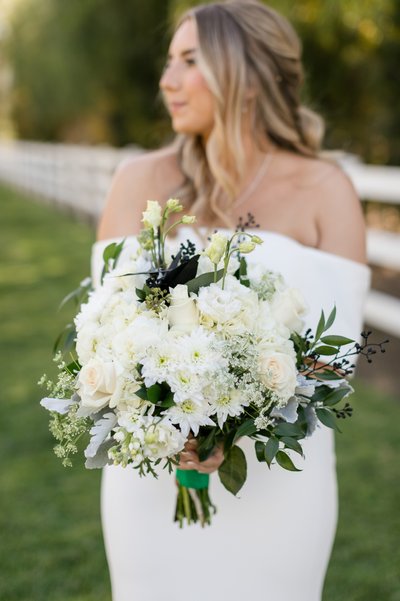 Bride with white bouquet at Rancho Guejito Vineyards.