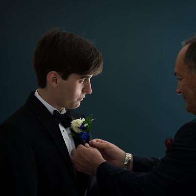 Groom with Boutonnière Being Pinned by His Father 