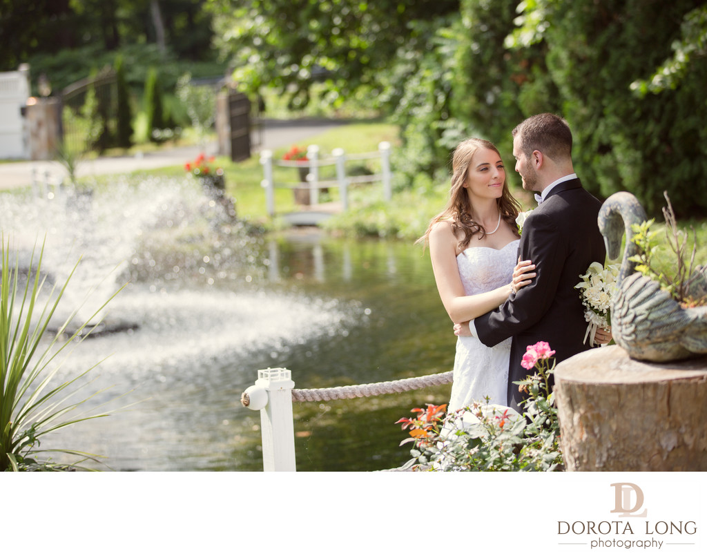 Wedding couple standing by a fountain danbury