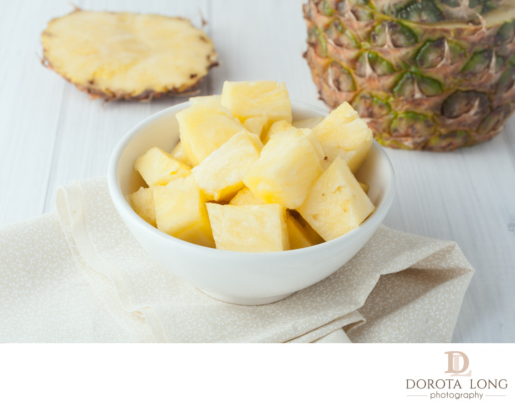 pineapple chunks in white bowl