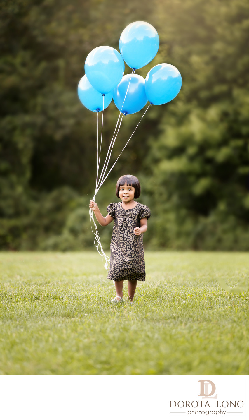 preschool little girl outdoor with baloons