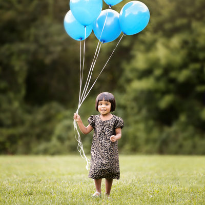 preschool little girl outdoor with baloons