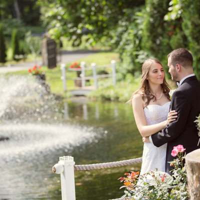 Wedding couple standing by a fountain danbury