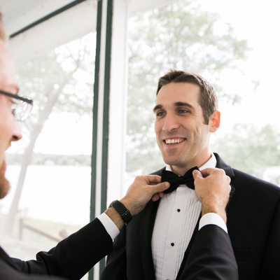 Best man helping the groom get ready. CT Wedding 