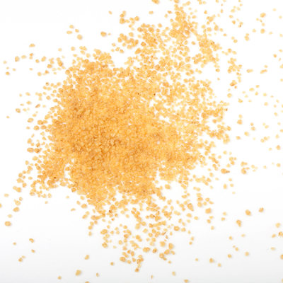 uncooked couscous scattered on white background