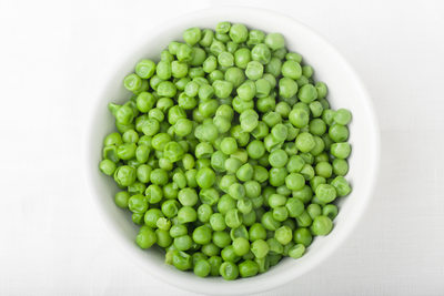 a bowl of cooked green peas, top view