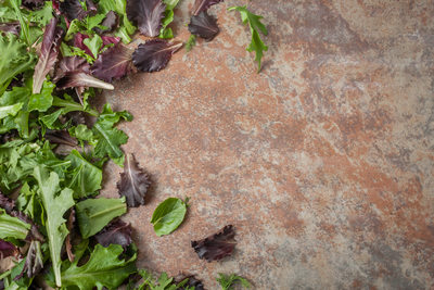 fresh lettuce leaves on textured background