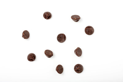 chocolate chips scattered on white background