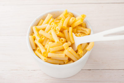 macaroni and cheese in a white cup