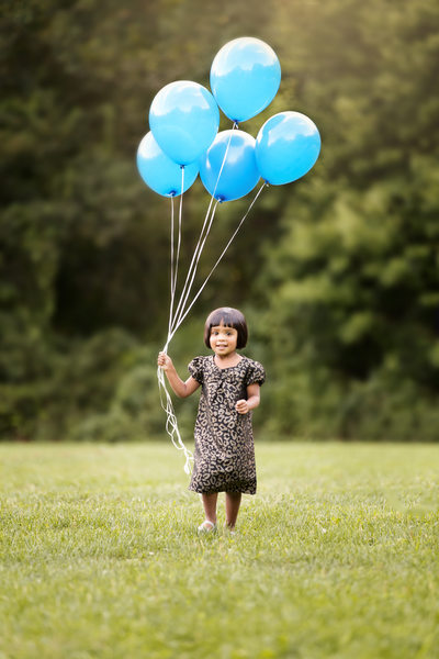 preschool little girl outdoor with baloons