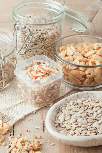 various nuts and seeds on wooden background