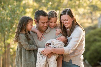 Family enjoying their newborn sister at Totness Recreation Park