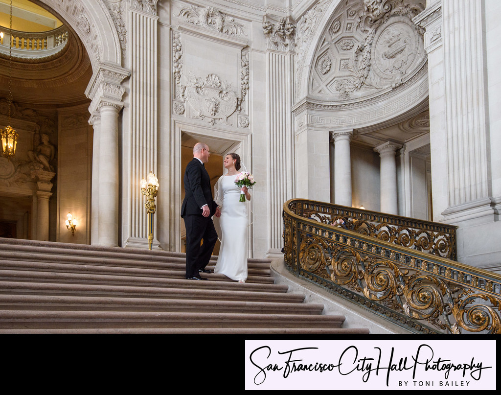 grand staircase with bride and groom walking down stairs