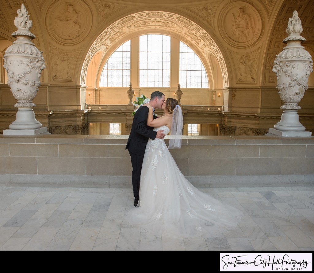 Groom kisses bride at San Francisco city hall wedding ceremony