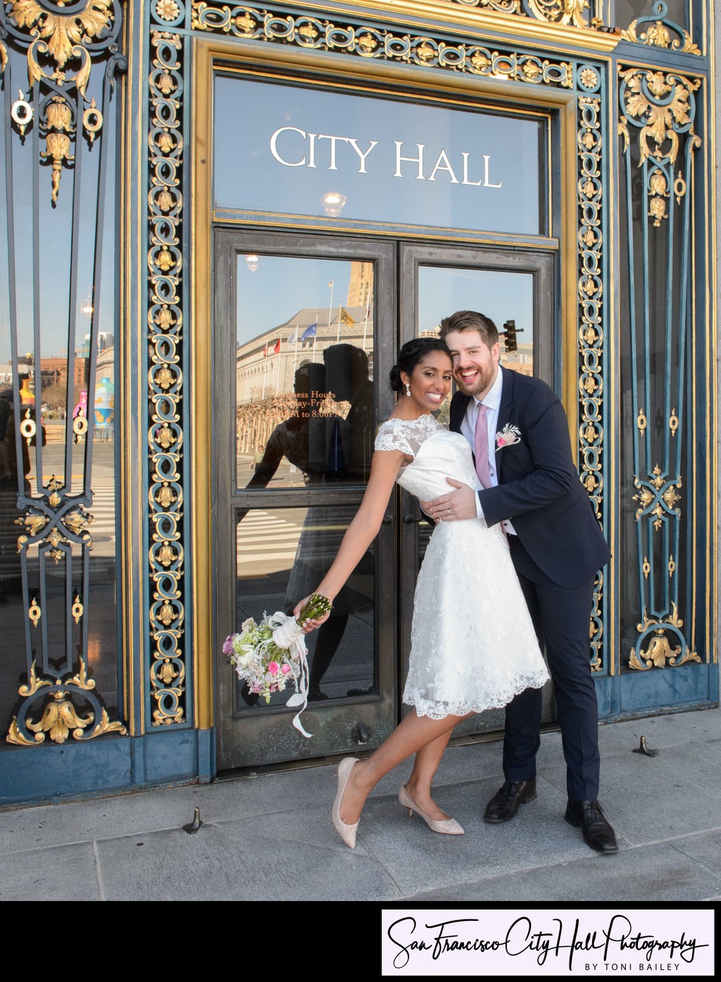 Bride and Groom hug outside of San Francisco city hall