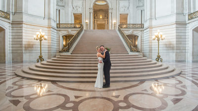Happily married at grand staircase in San Francisco