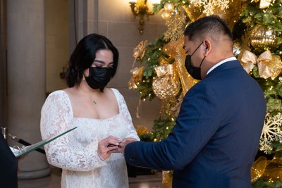 Bride and Groom wearing masks during ring exchange at SF City Hall