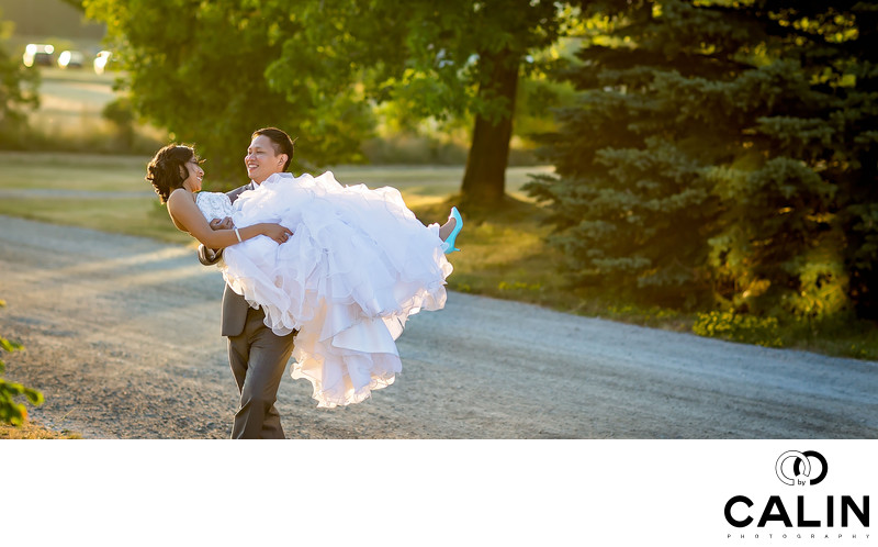 Groom Carries Bride at Country Heritage Park Wedding