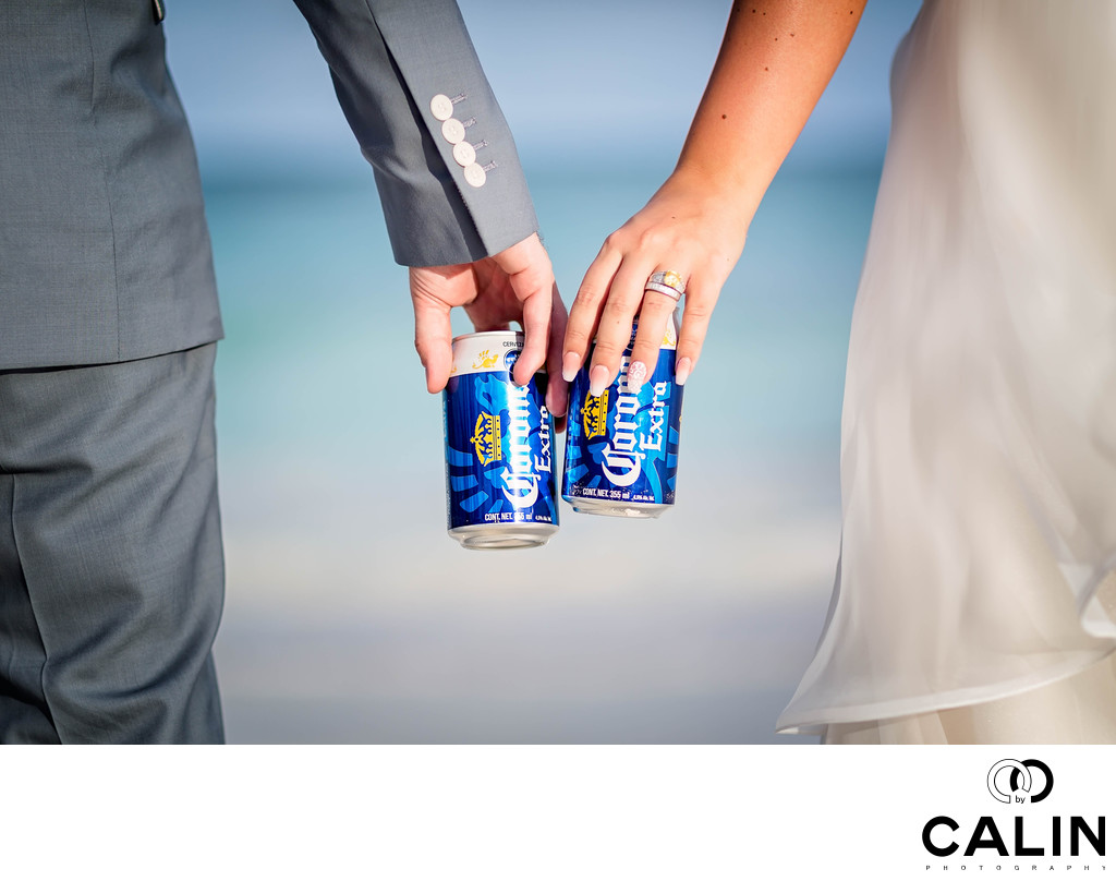 Bride and Groom Holding Beers on a Beach