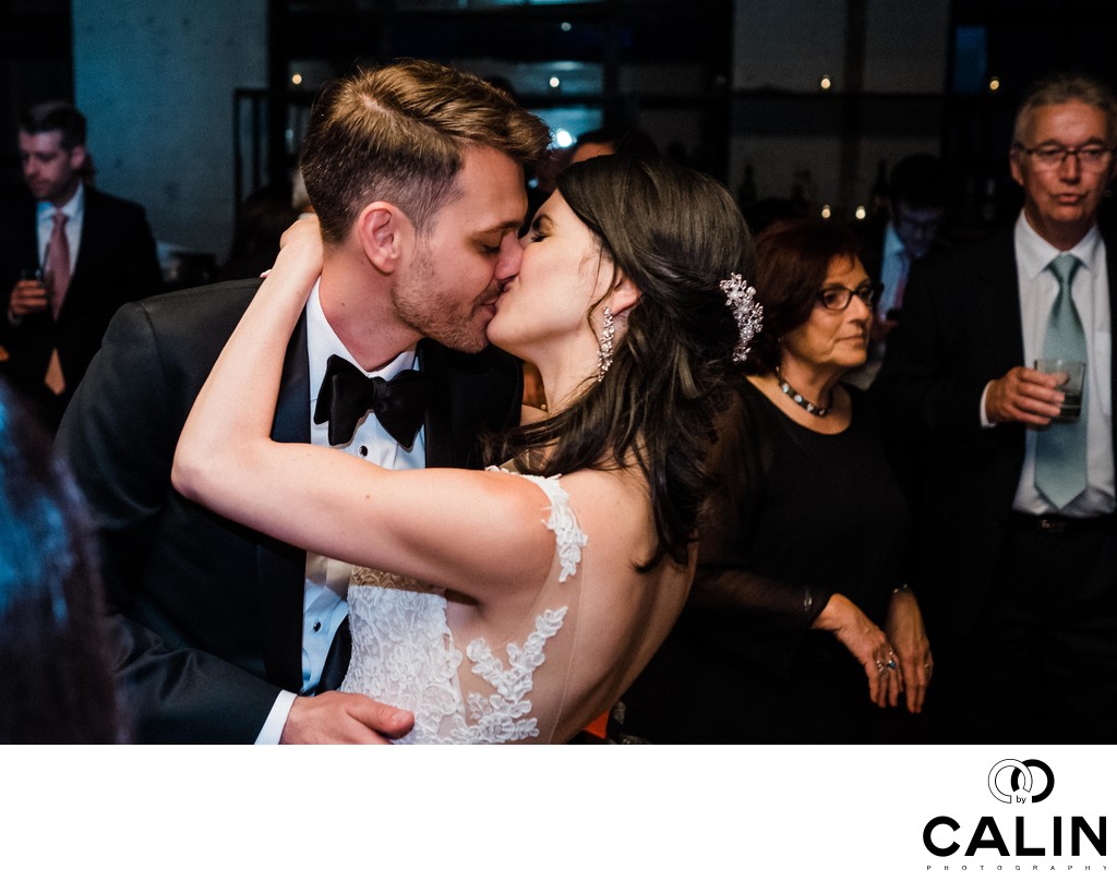 Bride and Groom Kiss at Storys Building Wedding