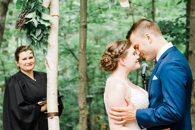 Officiant Smiles at Newlyweds