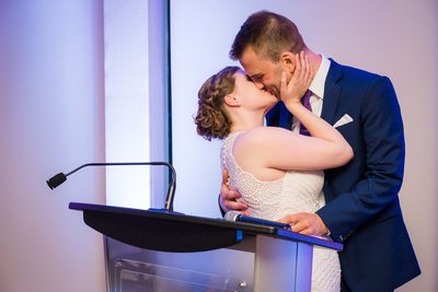 Newlyweds Kiss During Speech